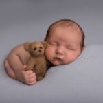 baby boy on a blue blanket with a brown teddy bear by Hull newborn photographer