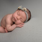 baby girl asleep on a sage green blanket by Hull newborn photographer