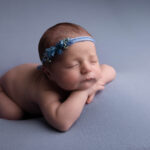 baby girl asleep on her tummy on a baby blue blanket by Hull newborn photographer